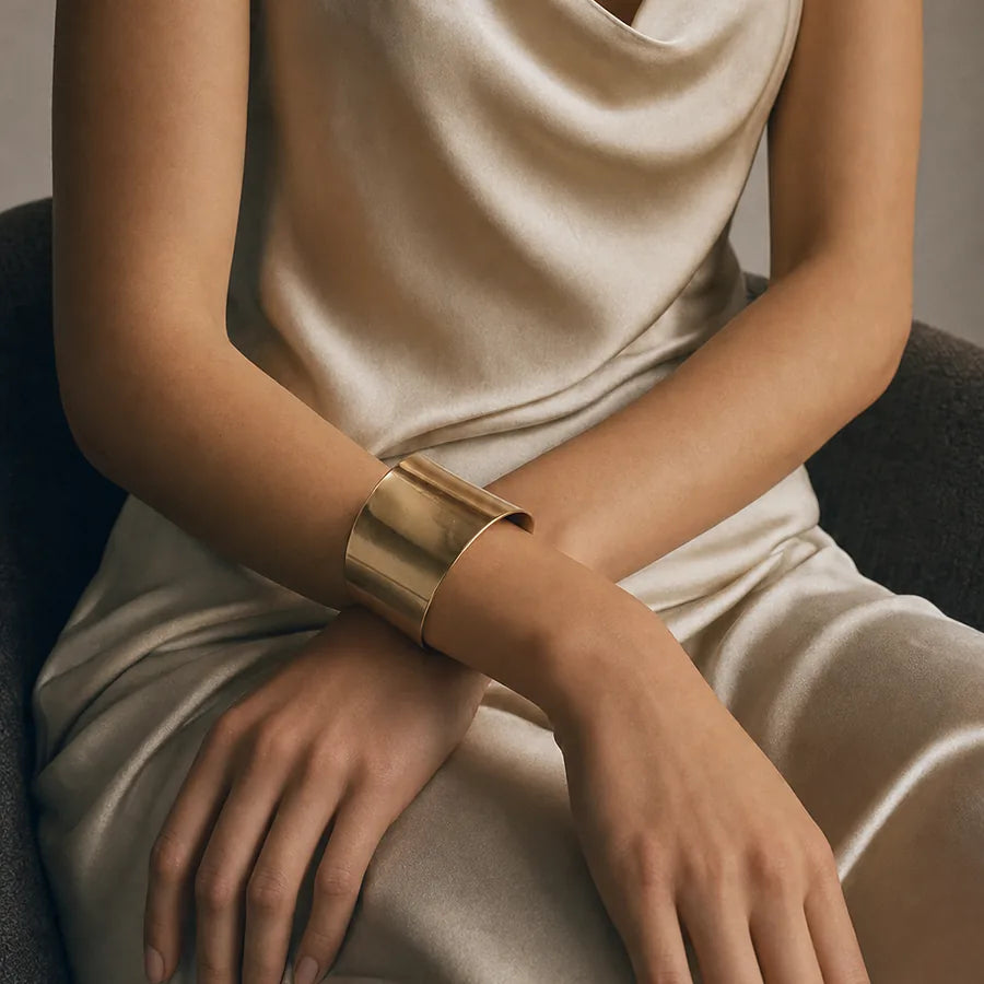 Ivory silk and a gold cuff